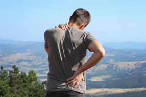 Man trying to manage pain while hiking 